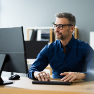 Man sat at desk in front of screen